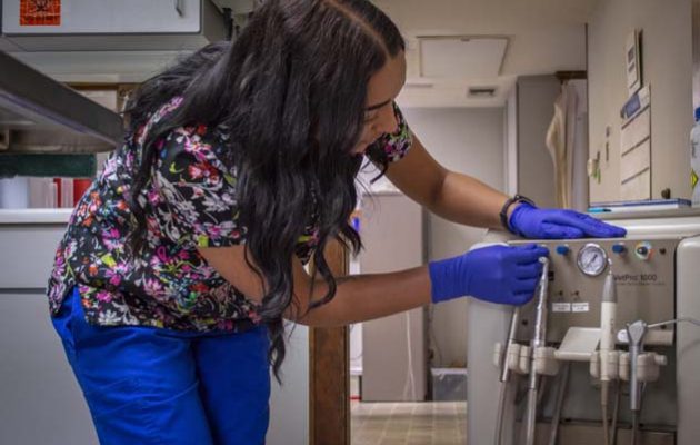 A team member turning on the dental tools