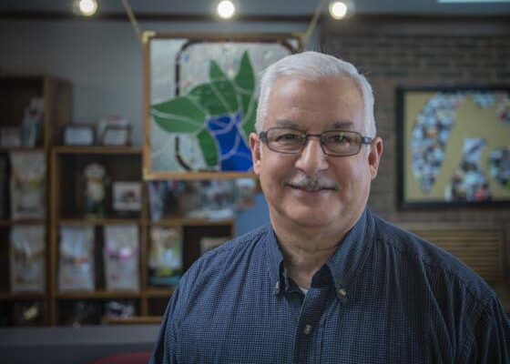 Dr. Kapoor smiling in the office